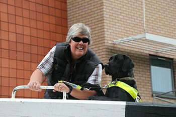 Tracey Clarke and Guide Dog Oakley at a lock beam.